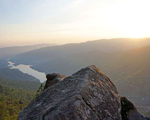 Stunning mountain landscape with river and sunset view, promoting adventure and travel exploration.