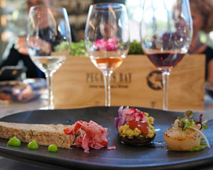Elegant wine tasting with three glasses and gourmet appetizers at Exclusivetravelbooking123 event.