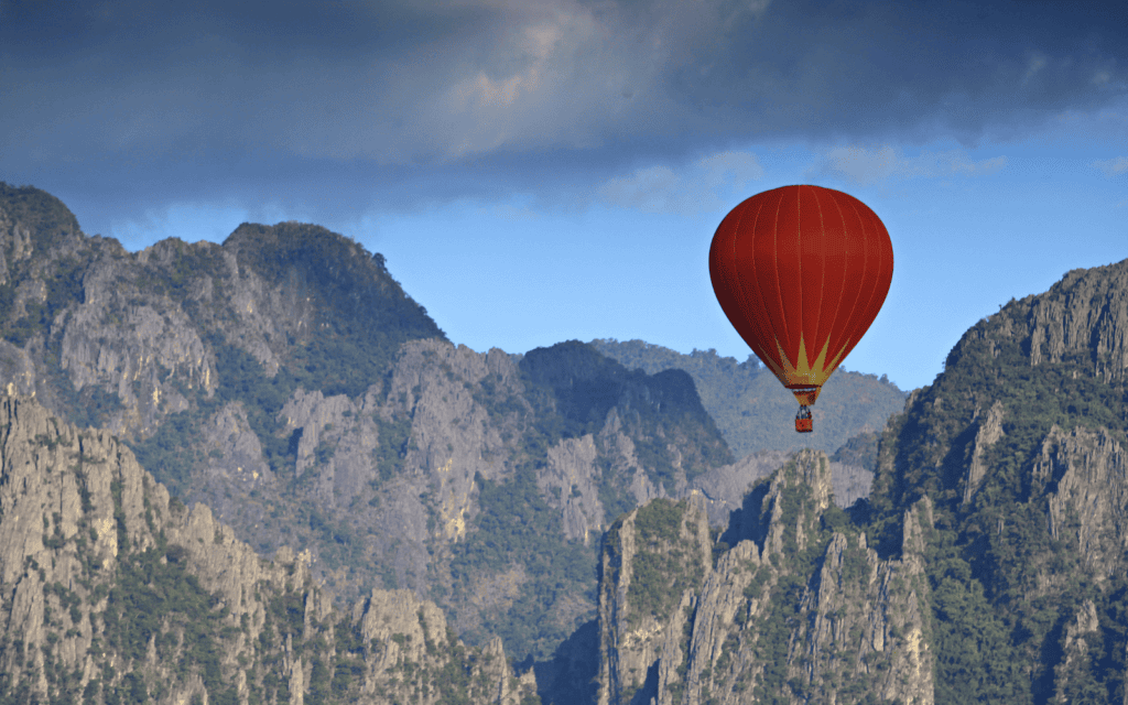 Hot air baloon floating over the limestone karsts of the adventure capital of Laos, Vang Vieng