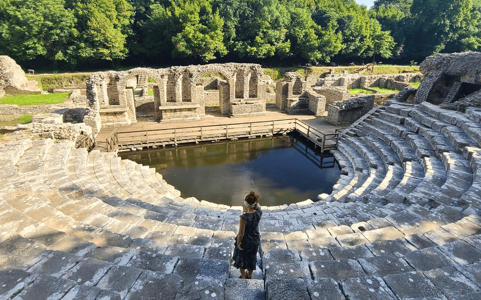 Woman standing in the ancient amphitheater of Butrint National Park, one of the best things to do in Ksamil, Albania-Photo by Abby Davis
