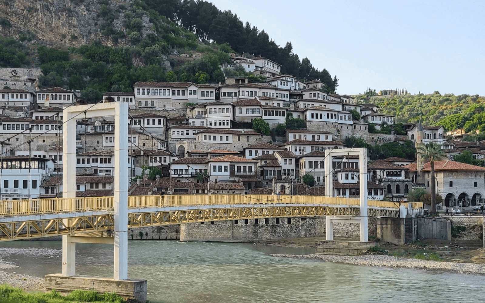 The traditional architecture of Berat Albania with a bridge and the Osum River in front-Photo by Abby Davis