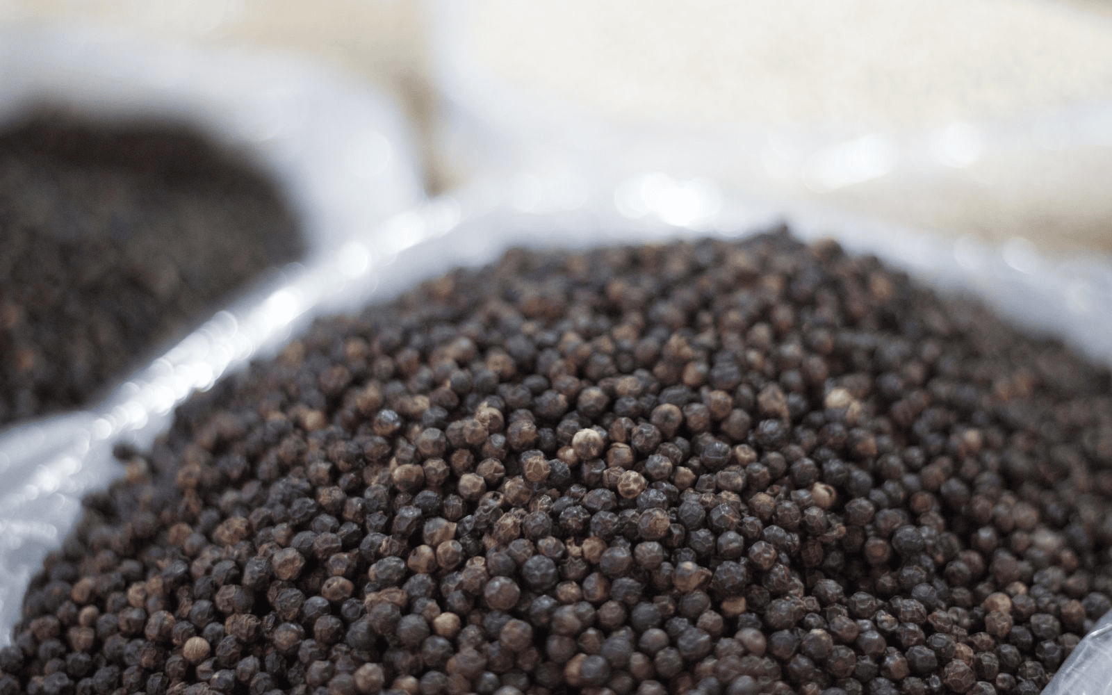 Barrel of black pepper on a blurred background