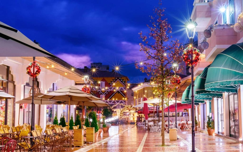 The New Bazaar in Zona 1, one of the top neighborhoods to stay in Tirana, at night with boutique shops and painted buildlings (2)