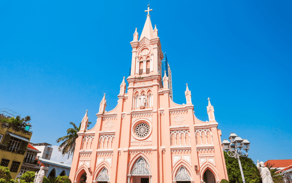 Pretty pink Da Nang Cathedral against a blue sky is a must vist stop on any Da Nang itinerary