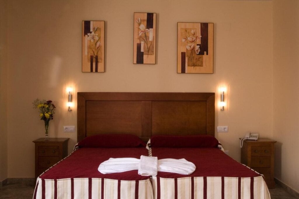 a small bedroom with warm lights and traditional design