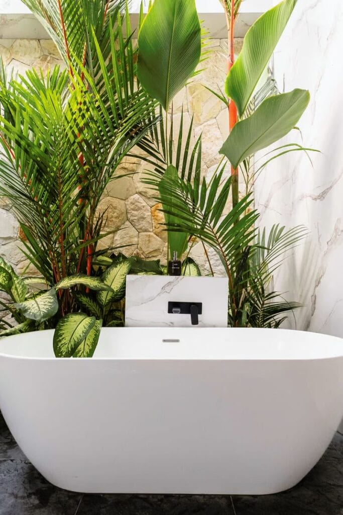 Lush tropical plants around modern bathtub for relaxing, wellness, and healing retreats.