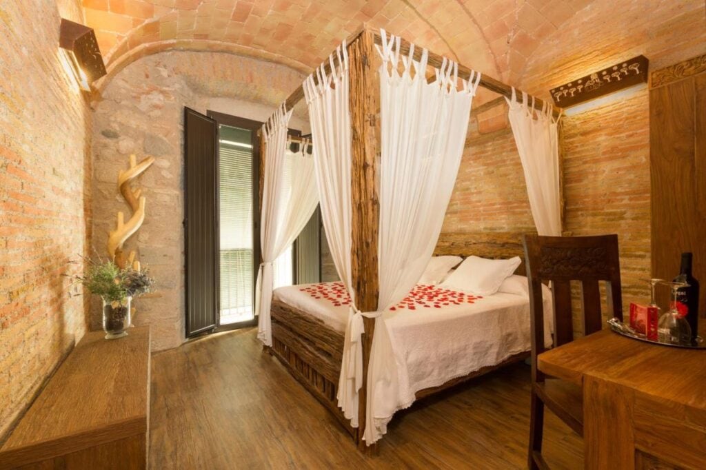 cozy bedroom with romantic setting and stone walls