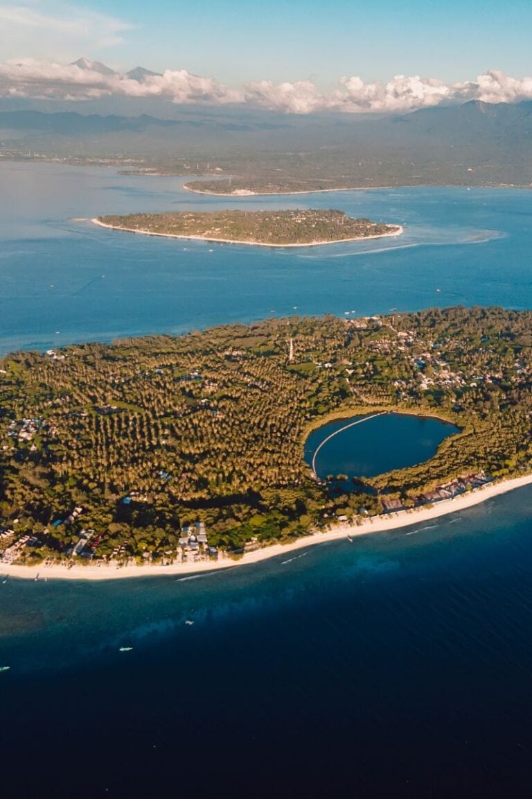 Serene coastal island with lush greenery and a circular lagoon, perfect for relaxing breathing exercises.