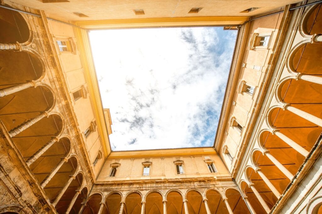 Interior of plaza at Bologna University with open sky