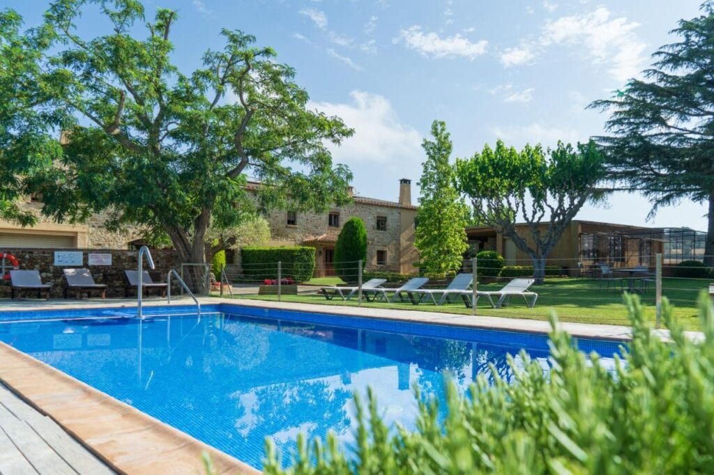 outdoor pool with lush gardens and traditional design building