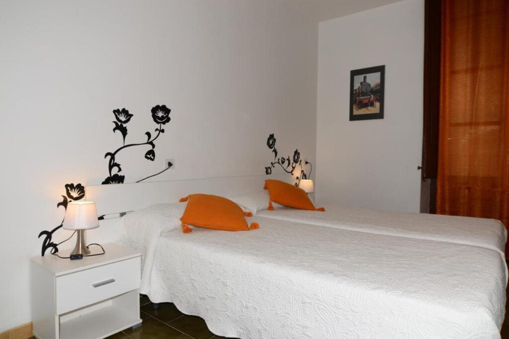 simple bedroom with white walls and beddings