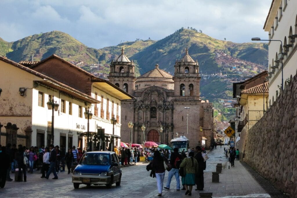 people walking down the street and mountain view from the streets of Cusco City