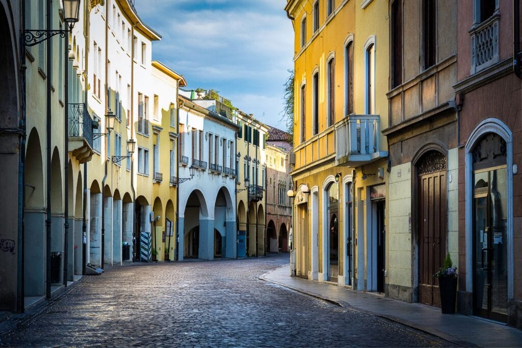 Arched architecture of Padua with cobblestone streets in the earlyl morning light