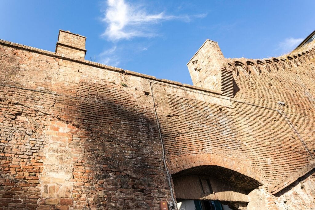 Towering Medieval walls of Siena from below