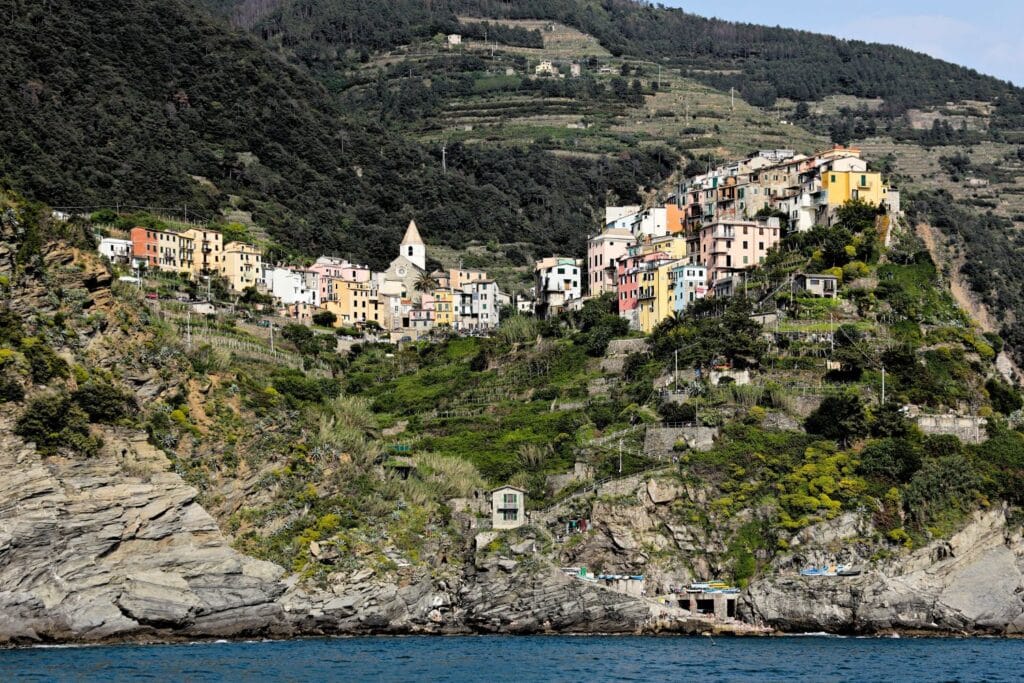 View of hilltop colored houses Corniglia from the sea