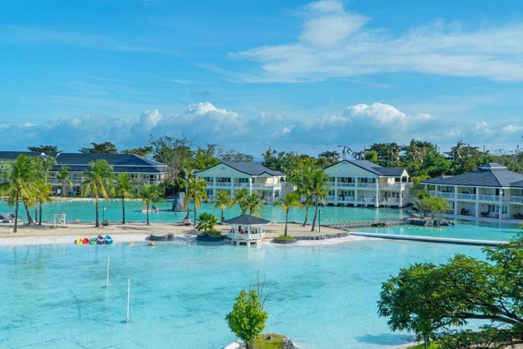 panoramic view of overwater bungalow resorts surrounded by crystal blue waters