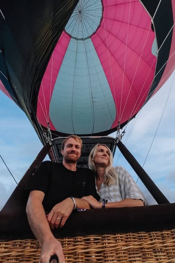 Hot air balloon ride with a couple, scenic sky backdrop, adventure travel experience, Exclusivetravelbooking123.
