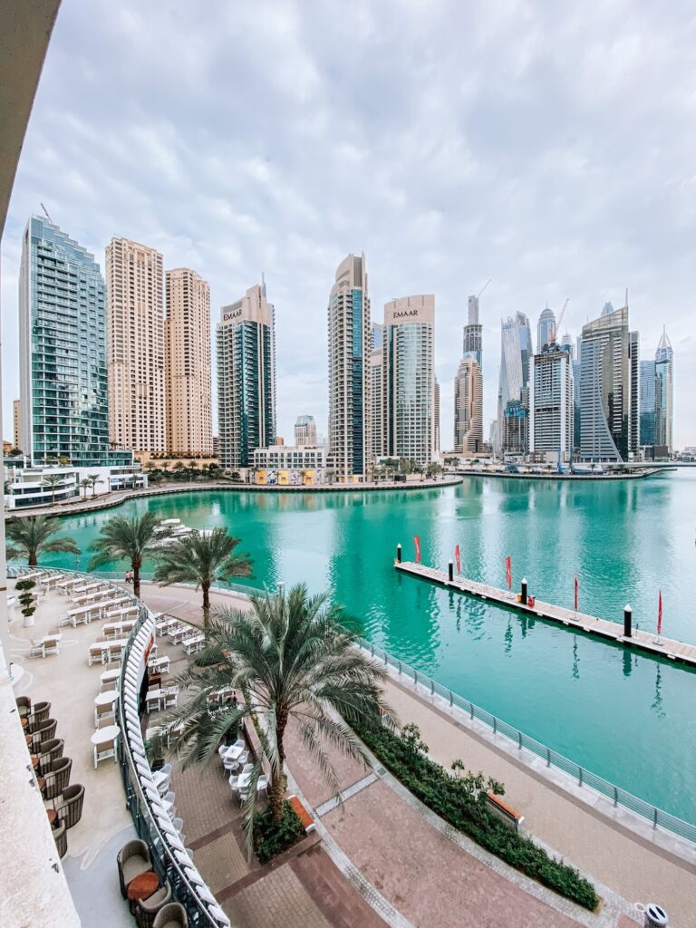Modern Dubai skyline with high-rise buildings and waterfront view, perfect for luxury travel and urban adventures.