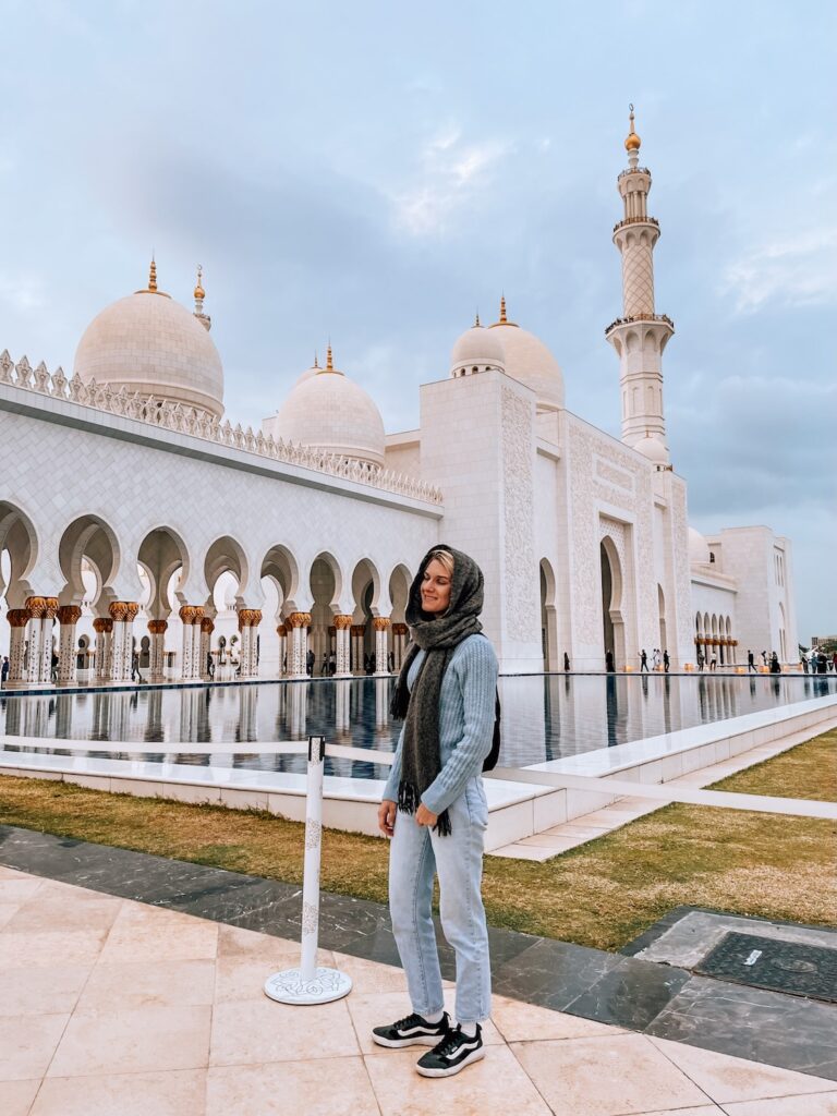 Impressive woman visiting the Sheikh Zayed Grand Mosque in Abu Dhabi, blending travel, culture, and sightseeing experiences.