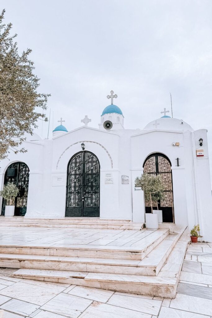 Beautiful white Greek church with blue domes in Athens.