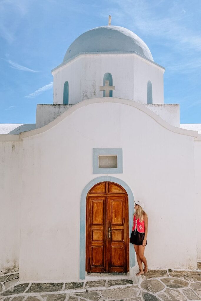 Traditional white Greek church with blue accents in Paros, Greece.