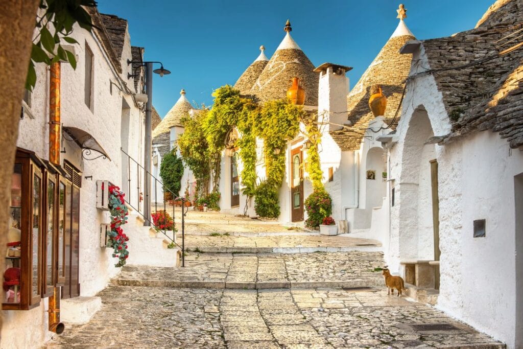 Charming Italian village with whitewashed houses and conical roofs, perfect for travel and eSIM use.